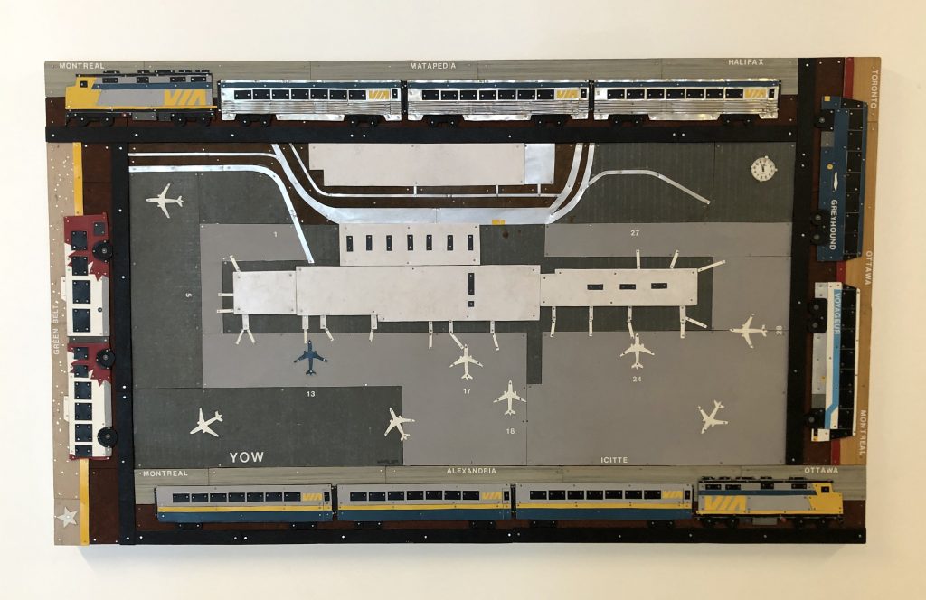 Made of pieces of thin sheet metal and rivets, this touchable artwork displays the Ottawa International Airport viewed from above. The airport is framed at the top and bottom by train cars and the sides by inner and inter city buses.